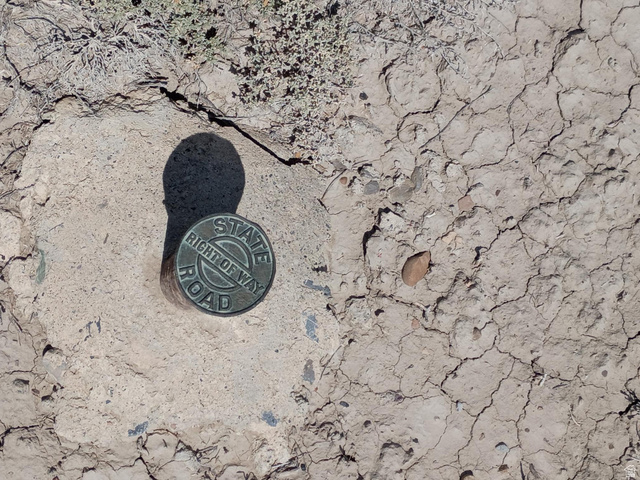 155 S Highway Cleveland, UT 84518 - Photo 13 of 13 Bronze survey marker embedded in parched earth, indicating a State Right of Way Road