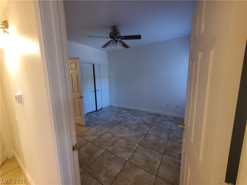 7255 West Sunset Road, Unit 1167 Las Vegas, NV 89113 - Photo 12 of 15 Empty room with light tile patterned flooring and a ceiling fan