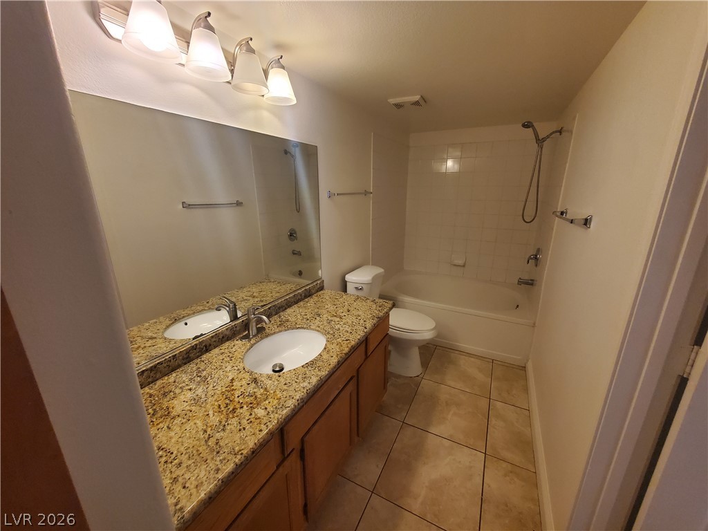 7255 West Sunset Road, Unit 1167 Las Vegas, NV 89113 - Photo 3 of 15 Bathroom featuring vanity, shower / bath combination, and light tile patterned floors
