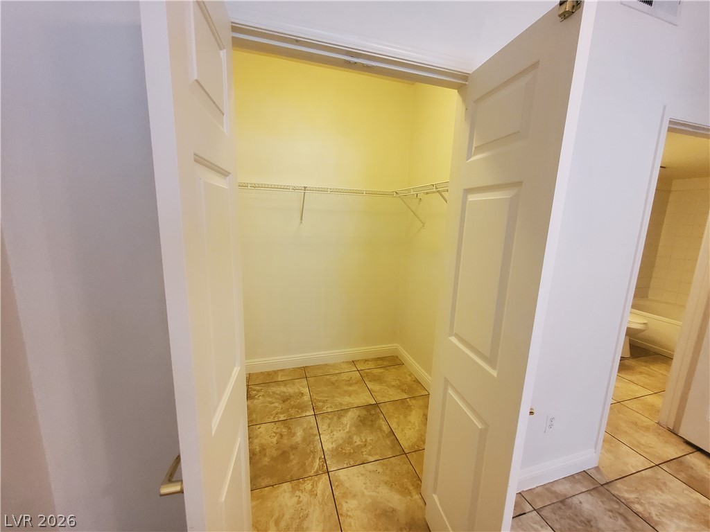 7255 West Sunset Road, Unit 1167 Las Vegas, NV 89113 - Photo 4 of 15 Walk in closet featuring light tile patterned floors
