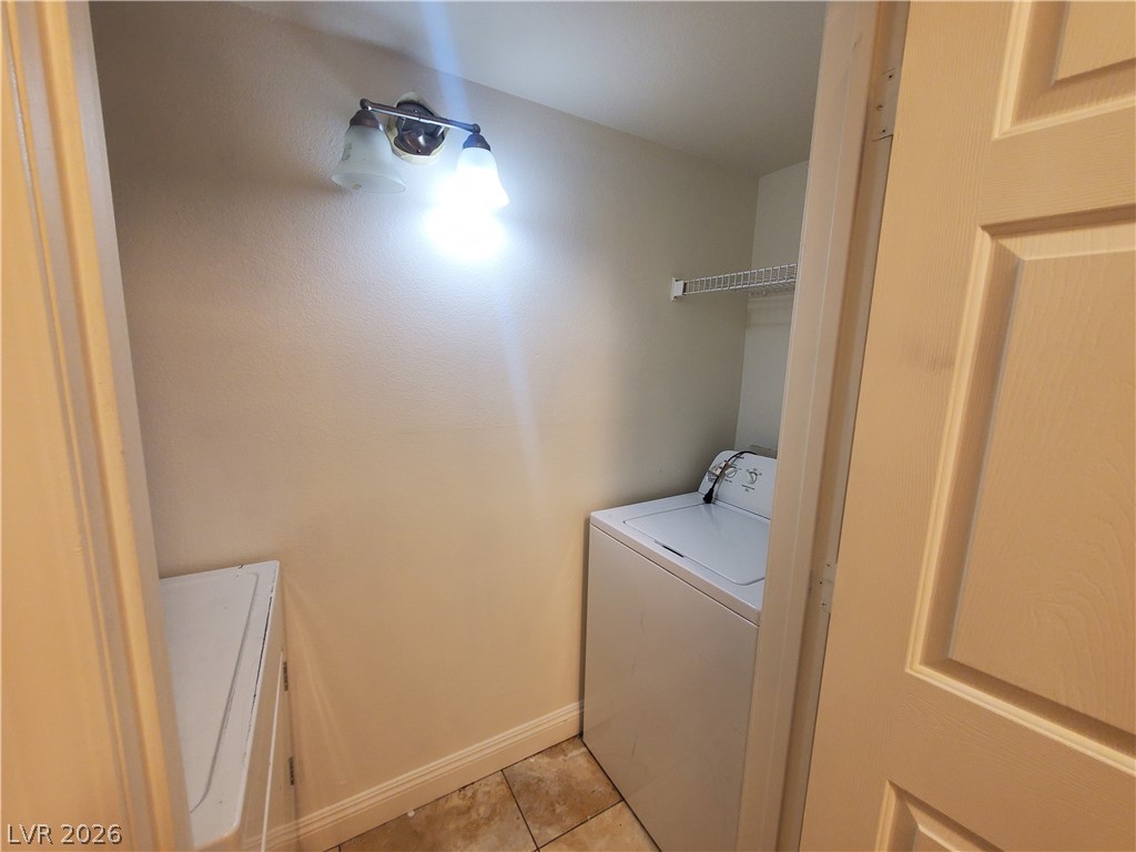 7255 West Sunset Road, Unit 1167 Las Vegas, NV 89113 - Photo 10 of 15 Laundry area with light tile patterned floors and washer and dryer