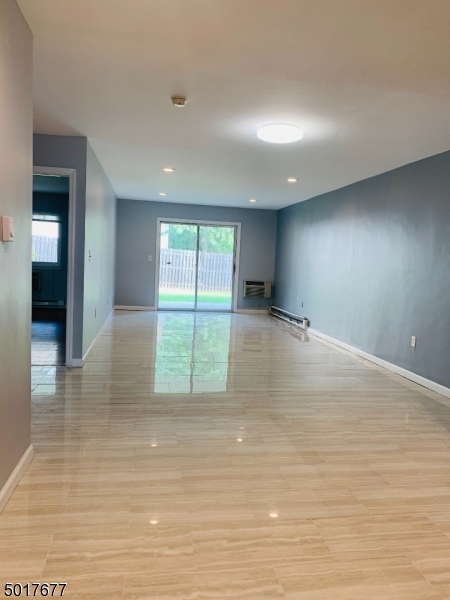 95 Park Street, Unit 3 Montclair, NJ 07042 - Photo 3 of 10 an empty room with wooden floor and windows
