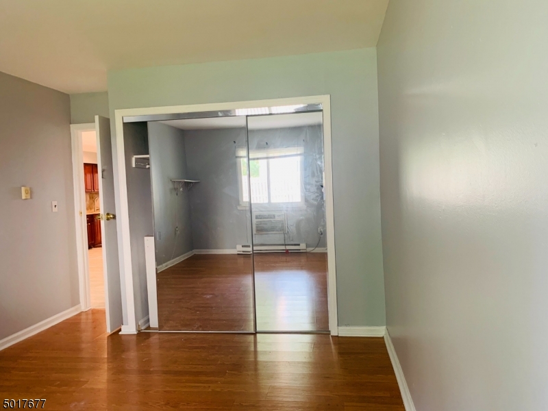 95 Park Street, Unit 3 Montclair, NJ 07042 - Photo 7 of 10 an empty room with wooden floor and windows