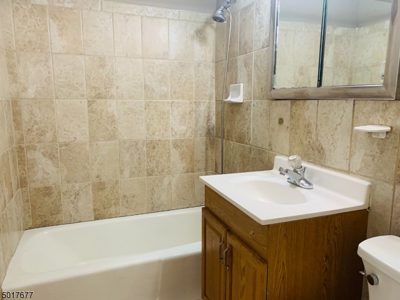 95 Park Street, Unit 3 Montclair, NJ 07042 - Photo 8 of 10 a bathroom with a sink a bathtub and a shower