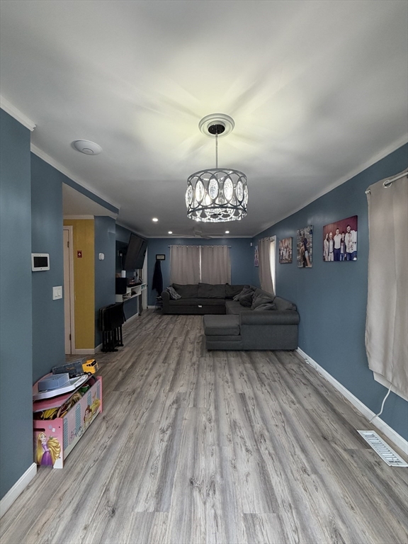 16 Linden Street Lynn, MA 01905 - Photo 12 of 23 a view of a dining room with furniture a chandelier and wooden floor