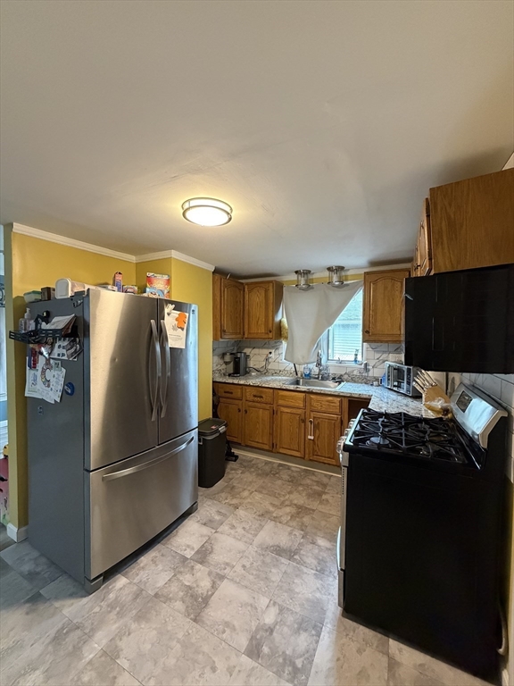 16 Linden Street Lynn, MA 01905 - Photo 6 of 23 a kitchen with stainless steel appliances granite countertop a refrigerator and a stove
