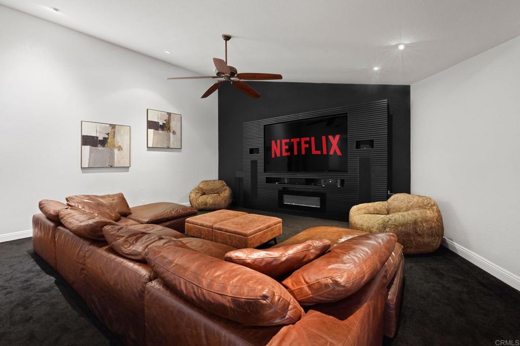7056 Del Cerro Boulevard San Diego, CA 92120 - Photo 17 of 34 a living room with furniture a flat screen tv and a lamp