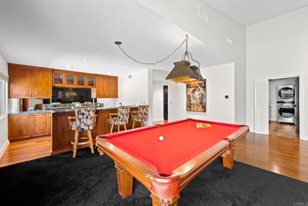 7056 Del Cerro Boulevard San Diego, CA 92120 - Photo 18 of 34 a room with table chairs and flat screen tv