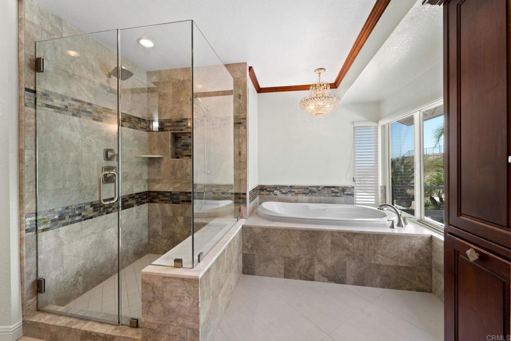 7056 Del Cerro Boulevard San Diego, CA 92120 - Photo 23 of 34 a bathroom with a tub and a shower
