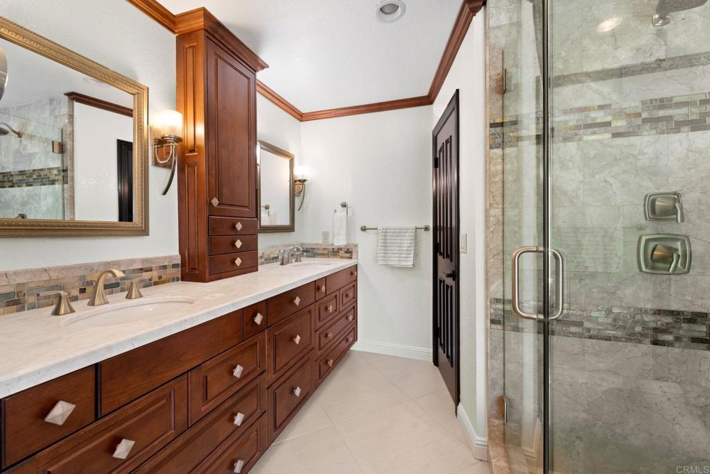 7056 Del Cerro Boulevard San Diego, CA 92120 - Photo 24 of 34 a spacious bathroom with a double vanity sink a mirror and a shower