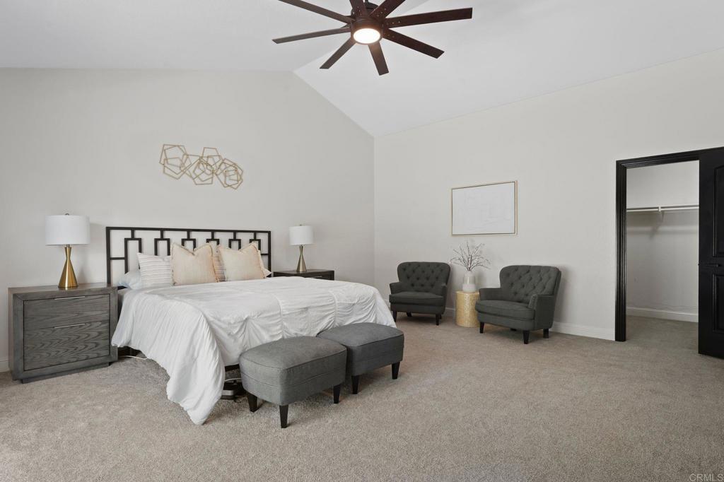 7056 Del Cerro Boulevard San Diego, CA 92120 - Photo 25 of 34 a bedroom with bed and a chandelier