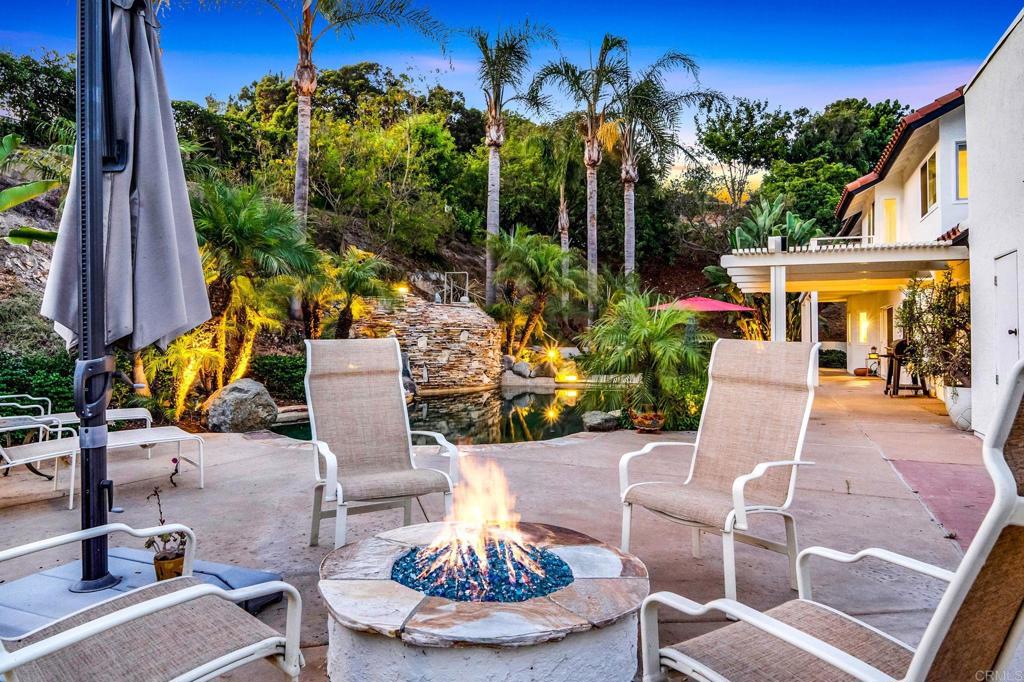 7056 Del Cerro Boulevard San Diego, CA 92120 - Photo 6 of 34 a view of a patio with table and chairs potted plants and a large tree