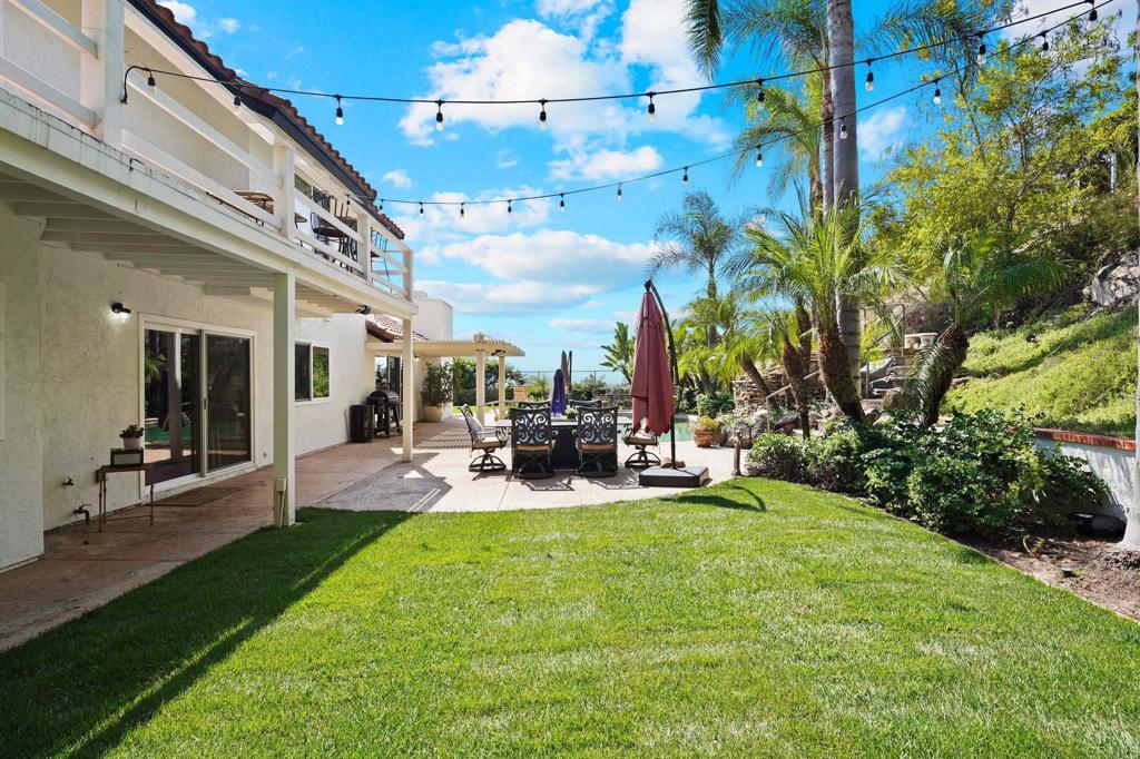 7056 Del Cerro Boulevard San Diego, CA 92120 - Photo 9 of 34 a view of a house with a yard and sitting area