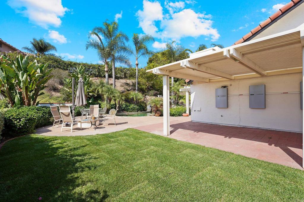 7056 Del Cerro Boulevard San Diego, CA 92120 - Photo 10 of 34 a view of a patio with table and chairs potted plants and palm tree