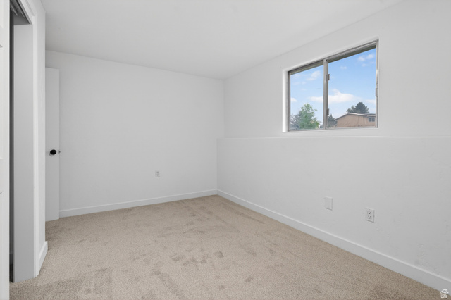 489 Owens Street Layton, UT 84041 - Photo 18 of 25 Empty room featuring light colored carpet and baseboards