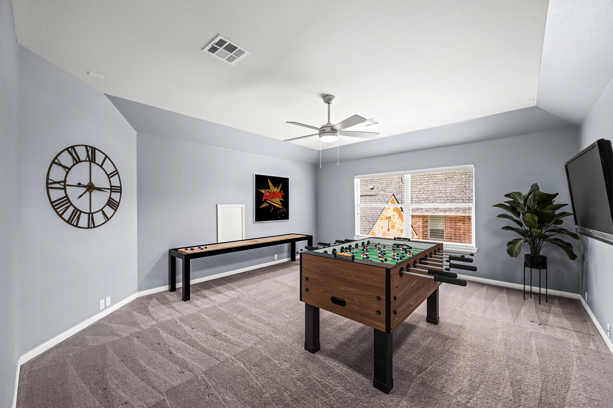 1023 Grassy Field Road Austin, TX 78737 - Photo 26 of 40 Spacious 5th bedroom featuring vaulted ceilings, a large window, a ceiling fan with integrated lighting. Virtually staged to show flexibility with large space.