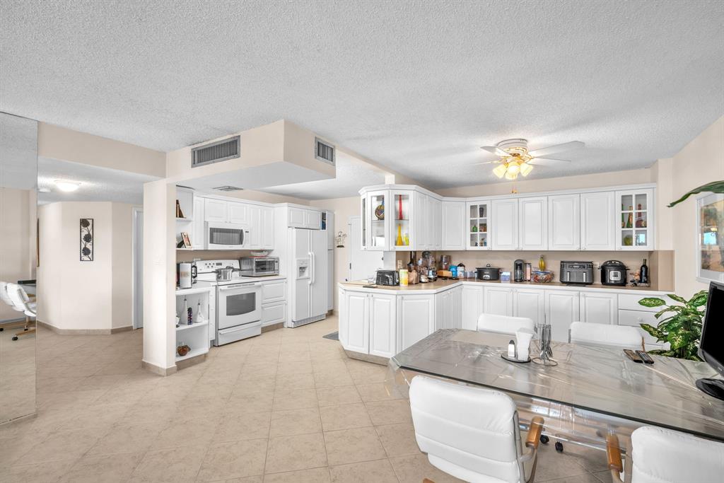 800 Northeast 195th Street, Unit 601 Miami, FL 33179 - Photo 15 of 35 a kitchen with counter top space cabinets and stainless steel appliances