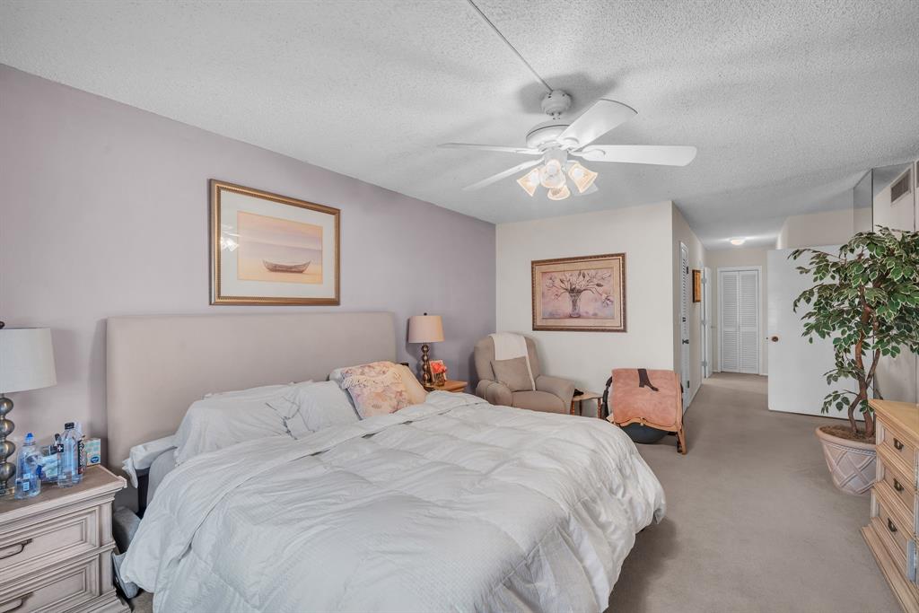 800 Northeast 195th Street, Unit 601 Miami, FL 33179 - Photo 18 of 35 a bedroom with a bed and a chandelier