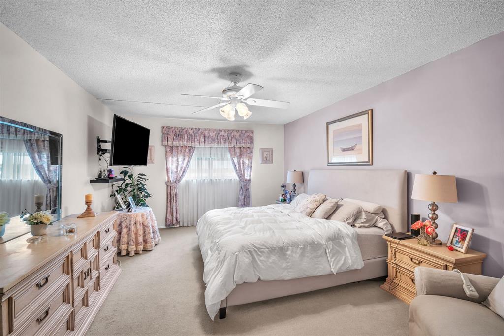 800 Northeast 195th Street, Unit 601 Miami, FL 33179 - Photo 19 of 35 a bedroom with a bed couch tv and a window