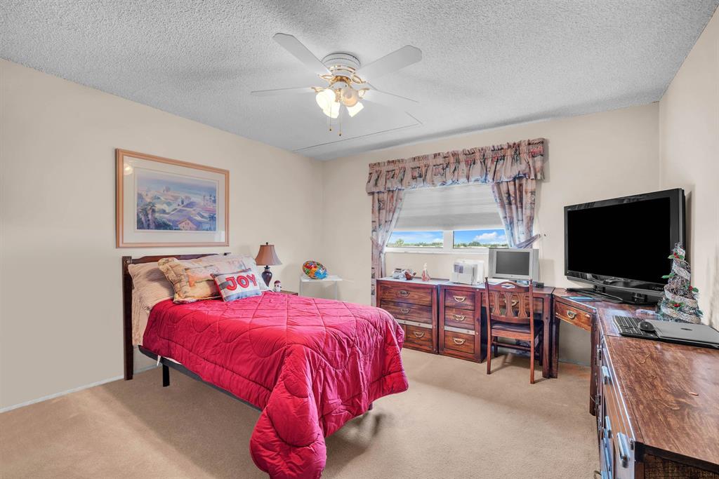 800 Northeast 195th Street, Unit 601 Miami, FL 33179 - Photo 22 of 35 a bedroom with a bed and a flat screen tv