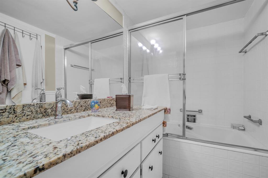 800 Northeast 195th Street, Unit 601 Miami, FL 33179 - Photo 23 of 35 a bathroom with a granite countertop sink mirror and a bathtub