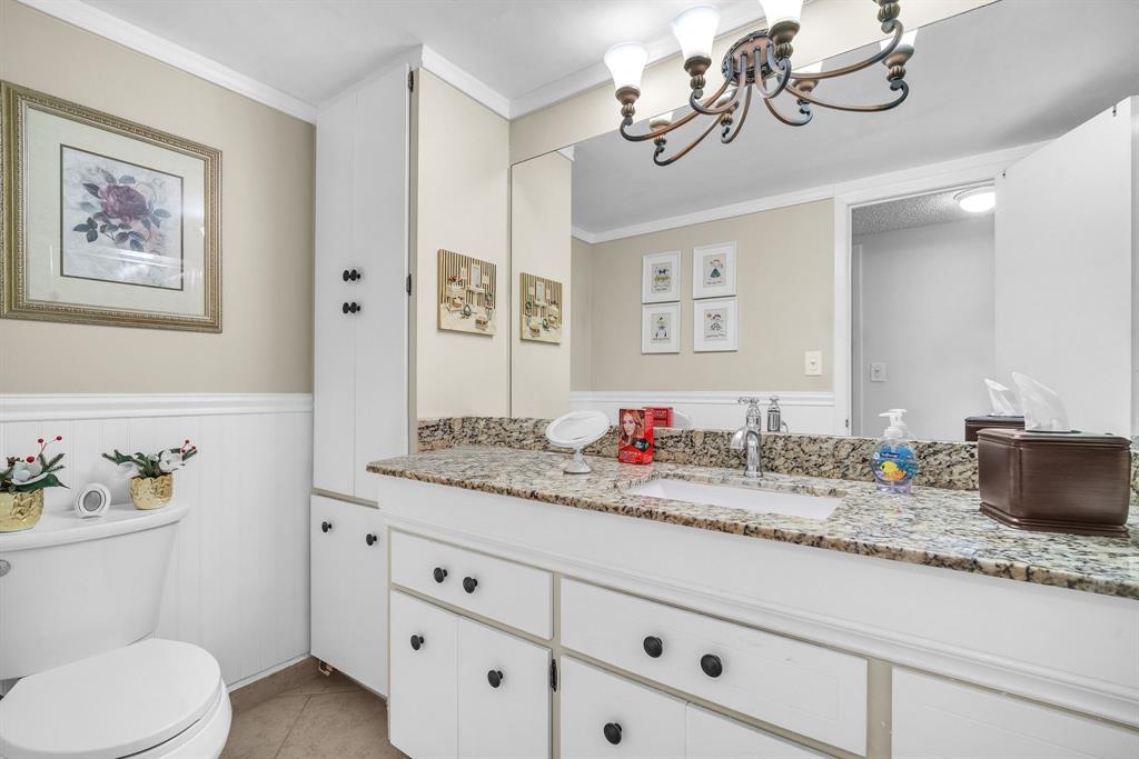 800 Northeast 195th Street, Unit 601 Miami, FL 33179 - Photo 24 of 35 a bathroom with a granite countertop sink mirror and toilet