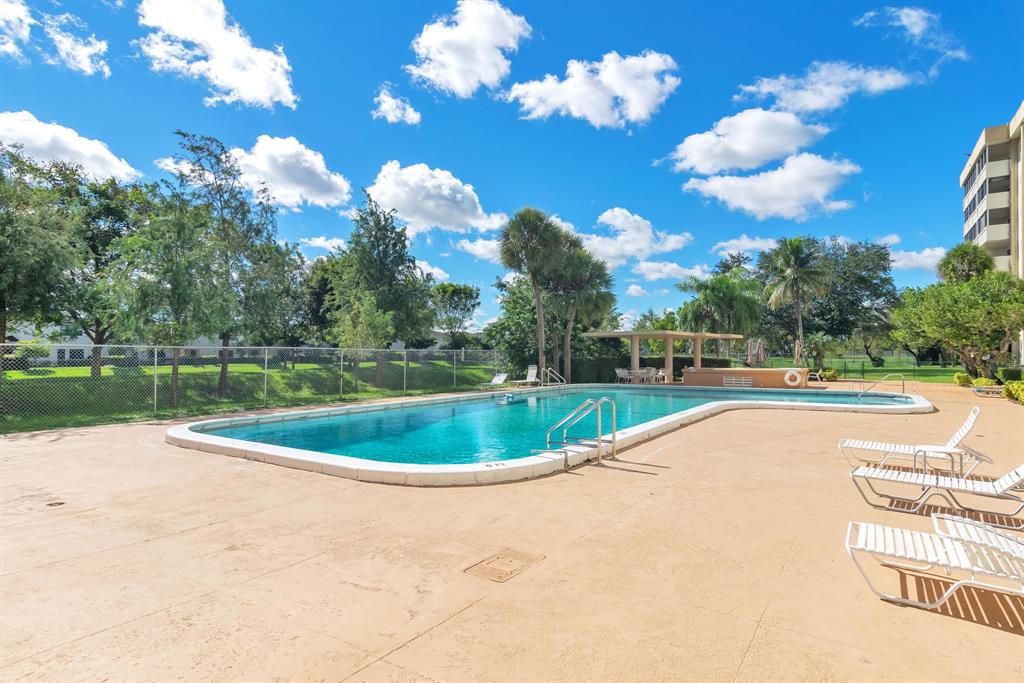 800 Northeast 195th Street, Unit 601 Miami, FL 33179 - Photo 32 of 35 a view of a swimming pool with a yard