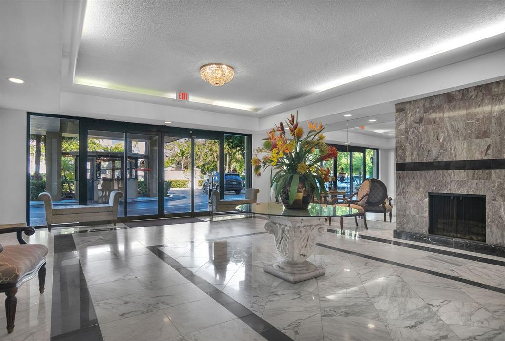 800 Northeast 195th Street, Unit 601 Miami, FL 33179 - Photo 33 of 35 a view of a lobby with black carpet and chandelier