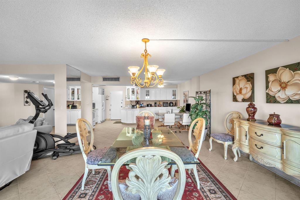 800 Northeast 195th Street, Unit 601 Miami, FL 33179 - Photo 6 of 35 a view of a dining room with furniture and chandelier
