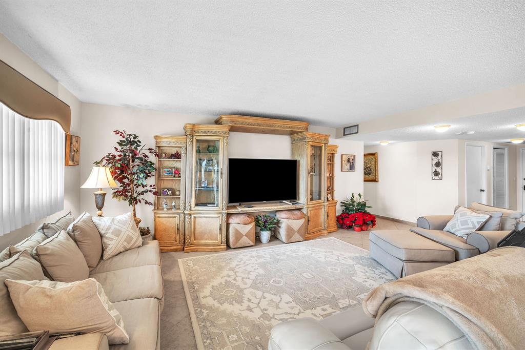 800 Northeast 195th Street, Unit 601 Miami, FL 33179 - Photo 7 of 35 a living room with furniture and a flat screen tv