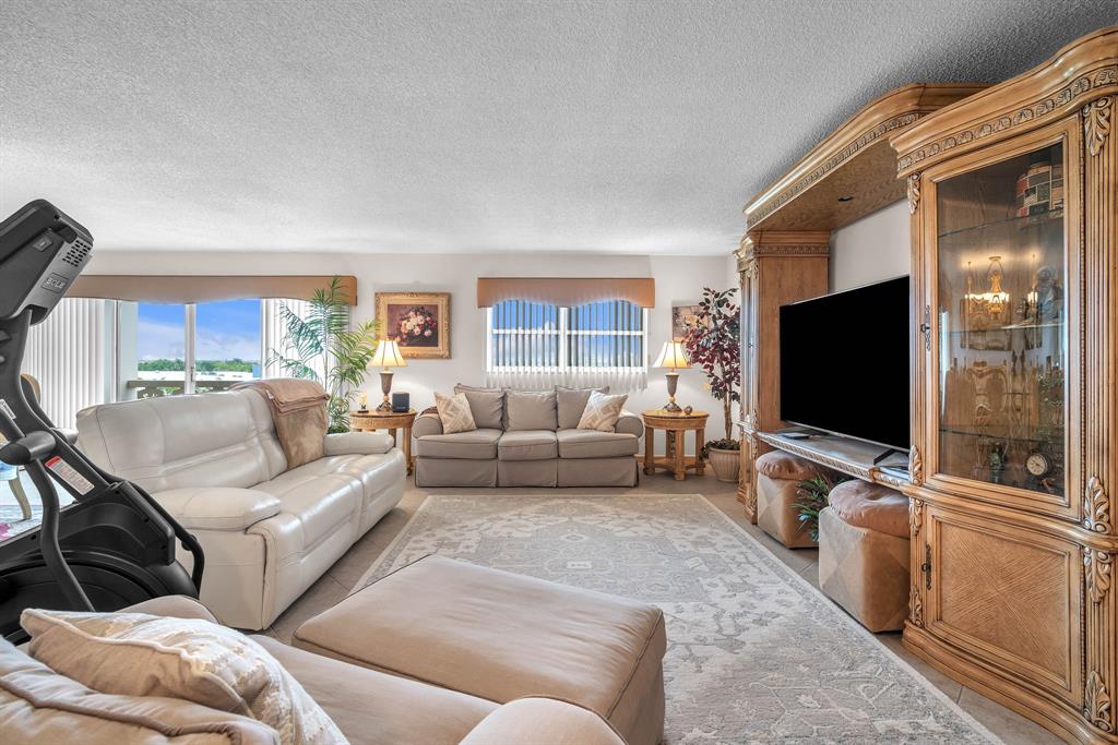 800 Northeast 195th Street, Unit 601 Miami, FL 33179 - Photo 9 of 35 a living room with furniture and a flat screen tv