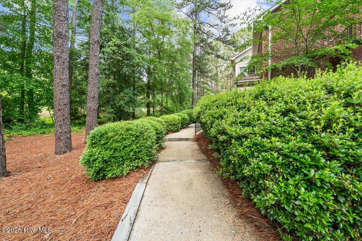 18 Pinehurst Mnr Road, Unit E Pinehurst, NC 28374 - Photo 2 of 19 Private walkway