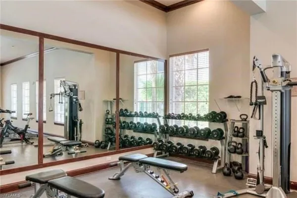 a room with gym equipment and a large window