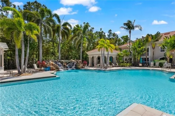 a view of a swimming pool and lounge chairs