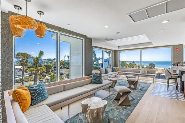 a living room with patio furniture and a large window