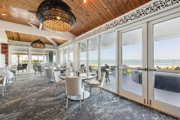 a room with lots of table chair