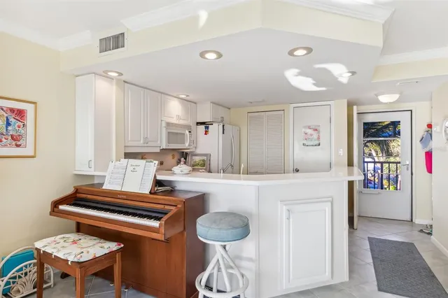 a room with furniture a piano and a table