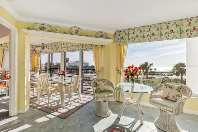 a view of a dining room with furniture one side kitchen view
