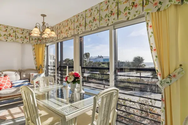 a dining room with furniture a chandelier and window