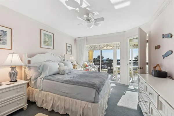 a bedroom with bed and a large mirror