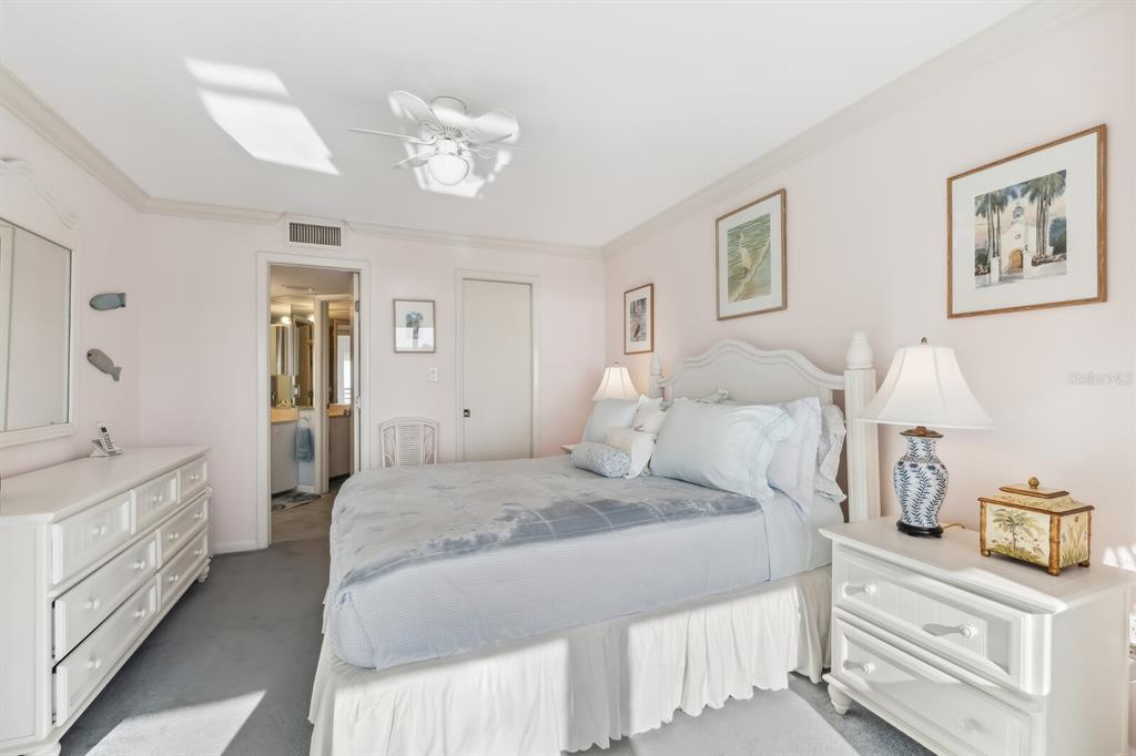 5000 Gasparilla Road, Unit BC203 Boca Grande, FL 33921 - Photo 10 of 34 a spacious bedroom with a bed and a chandelier