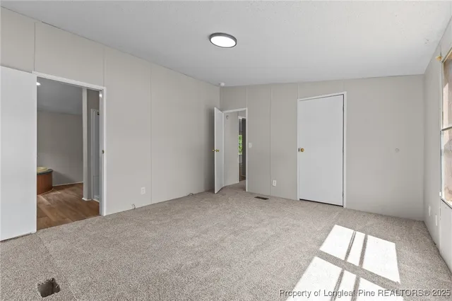 a bathroom with a granite countertop double vanity sink and a mirror