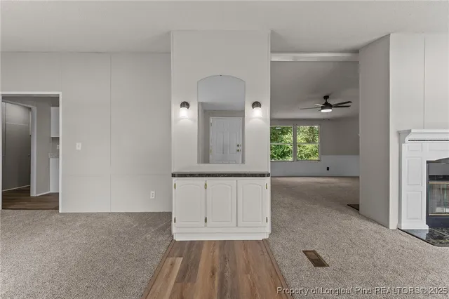 a view of a livingroom with a ceiling fan and window