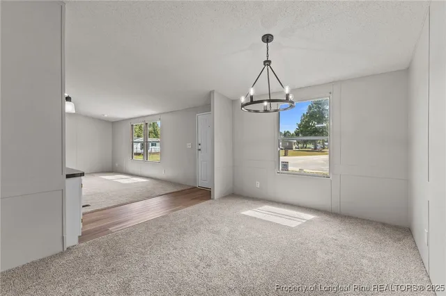 a view of a kitchen with an empty space and a window