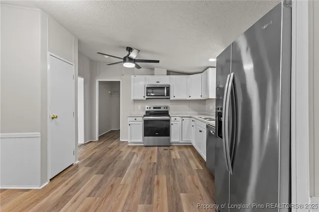 a kitchen with a stove a sink and a refrigerator
