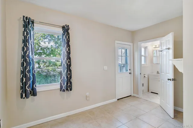 an empty room with windows and closet