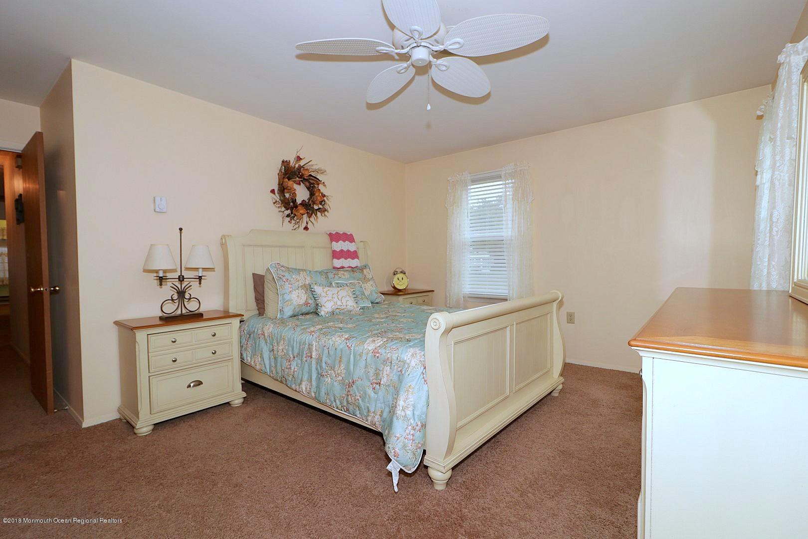 34 B Mill Road Whiting, NJ 08759 - Photo 11 of 22 a spacious bedroom with a bed and a dresser