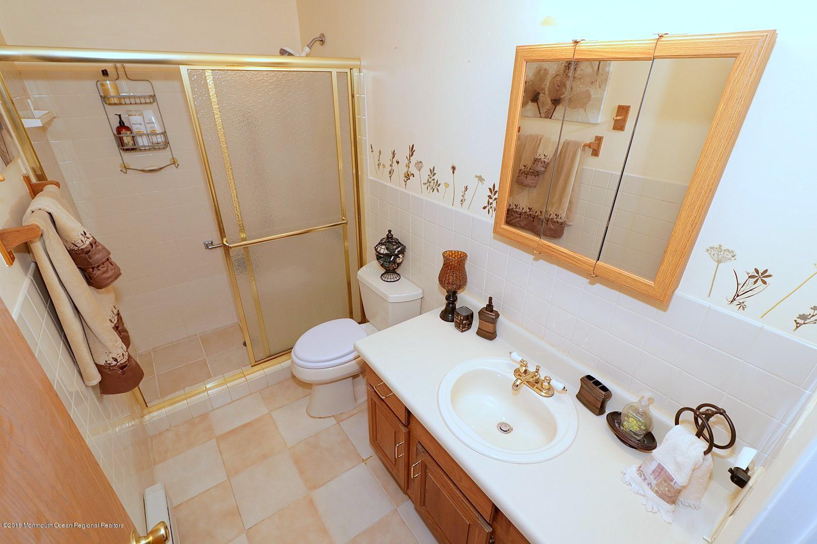 34 B Mill Road Whiting, NJ 08759 - Photo 14 of 22 a bathroom with a sink a toilet and a mirror