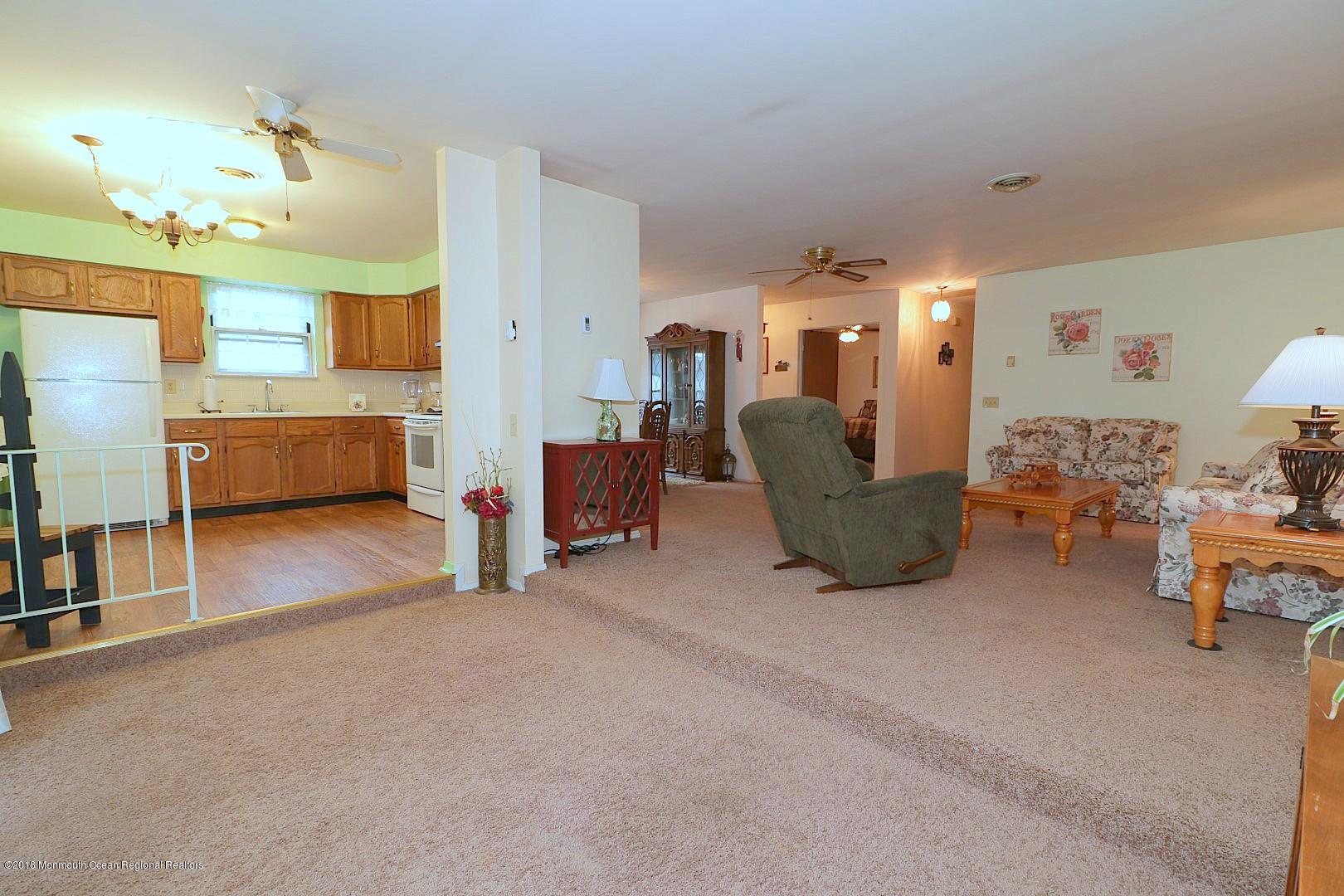 34 B Mill Road Whiting, NJ 08759 - Photo 20 of 22 a living room with furniture and a chandelier