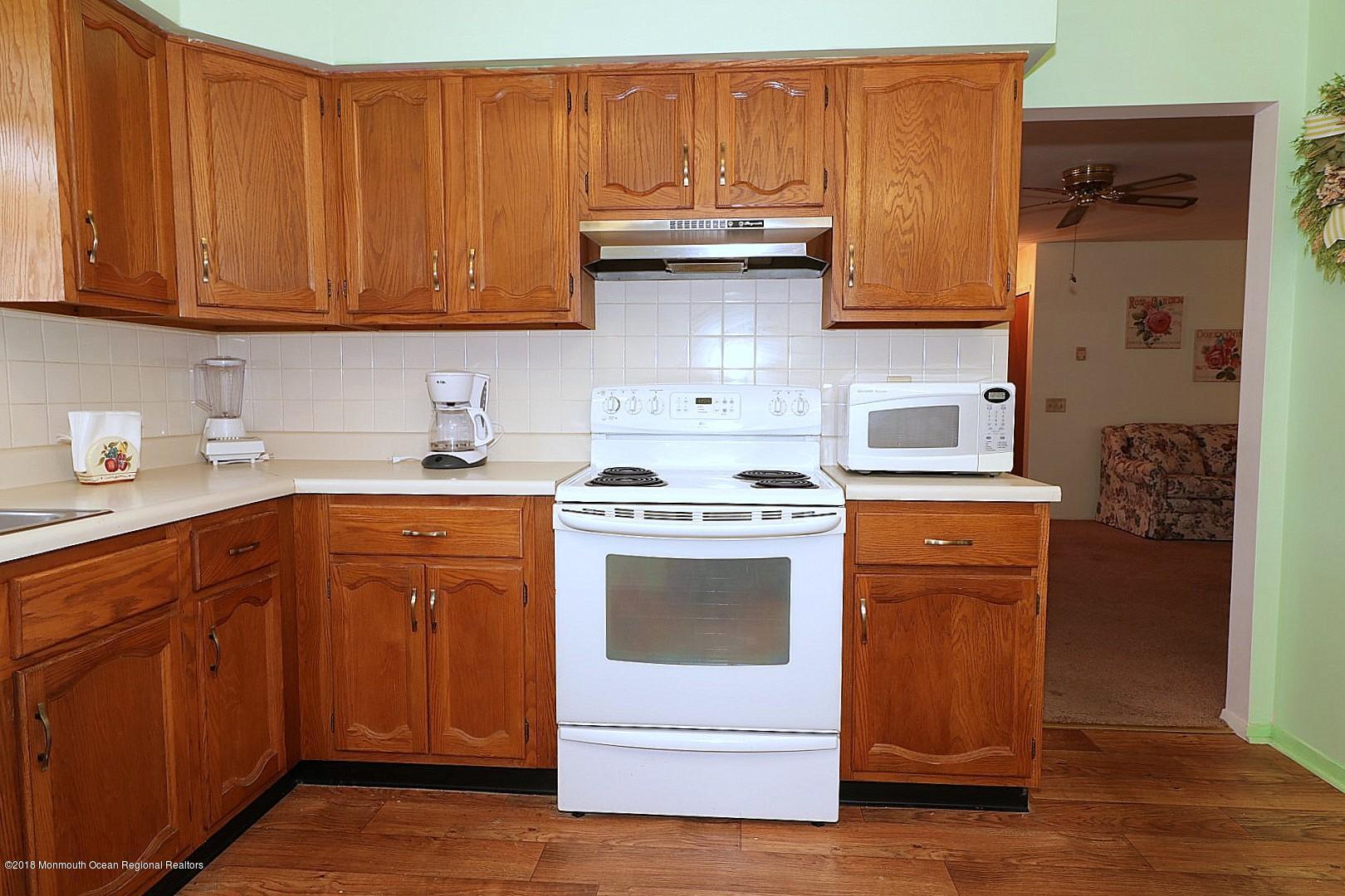 34 B Mill Road Whiting, NJ 08759 - Photo 9 of 22 a kitchen with stainless steel appliances granite countertop a stove and a refrigerator